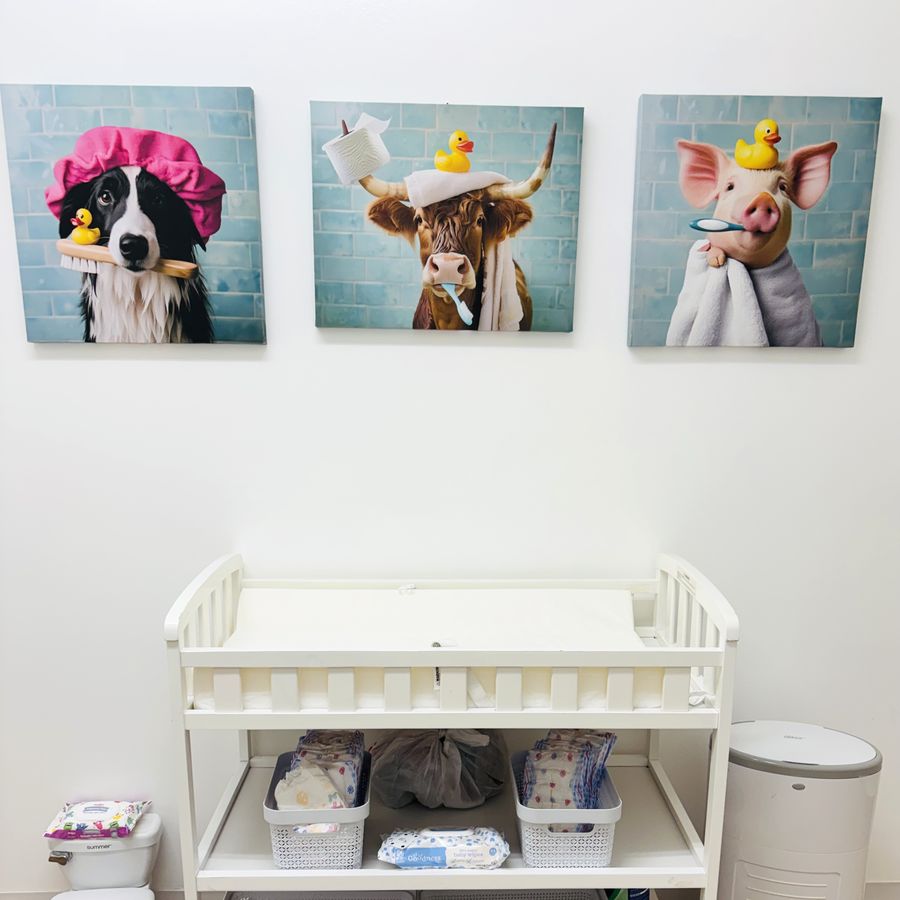 The bathroom: a changing table stocked with diapers and wipes, a toddler-sized potty and a diaper pail.